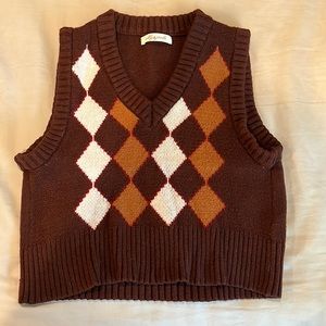 small cardigan with a brown base and tan/white squares